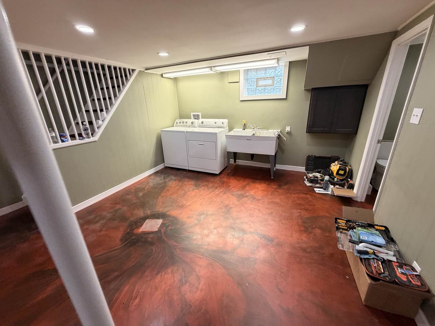 Finished red and black metallic epoxy basement floor